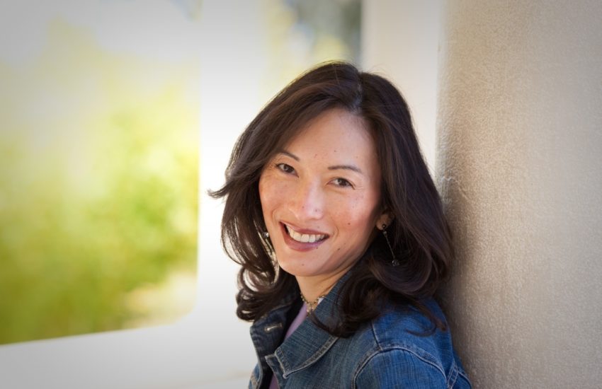 women with dark shoulder hair in a jean jacket